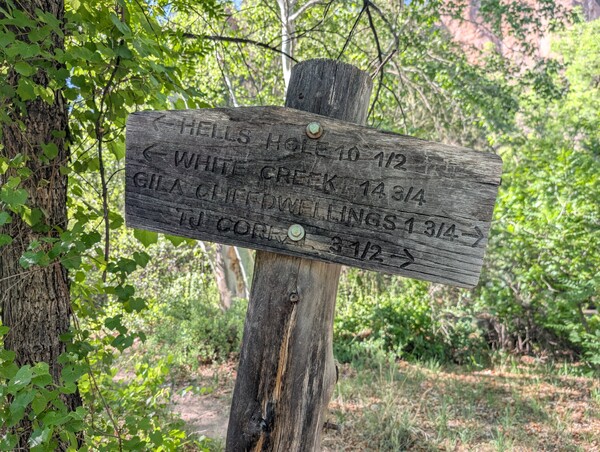 Wooden trail sign pointing to the Gila Cliff Dwellings